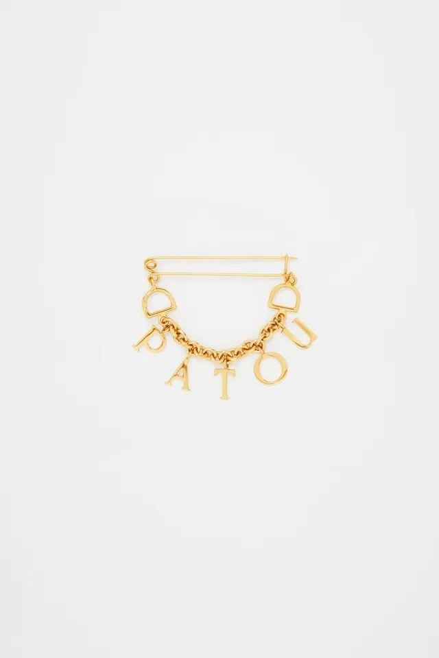 Patou P23JW0991002299G broche laiton doré Gold lettres